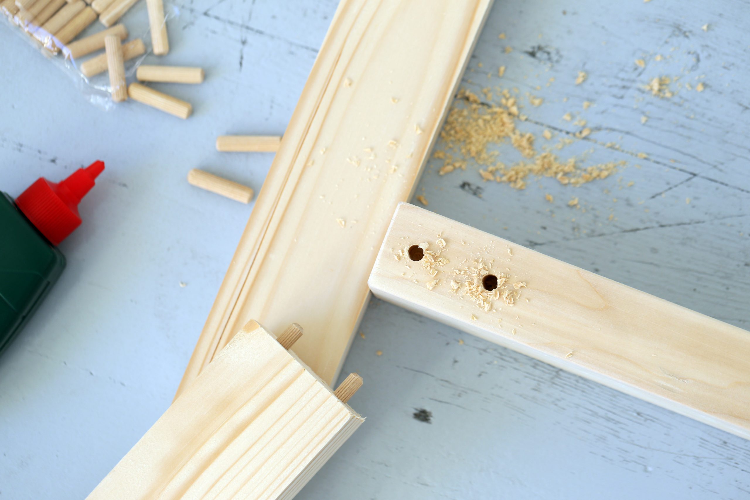 Closeup pictures of a wooden bar being drilled